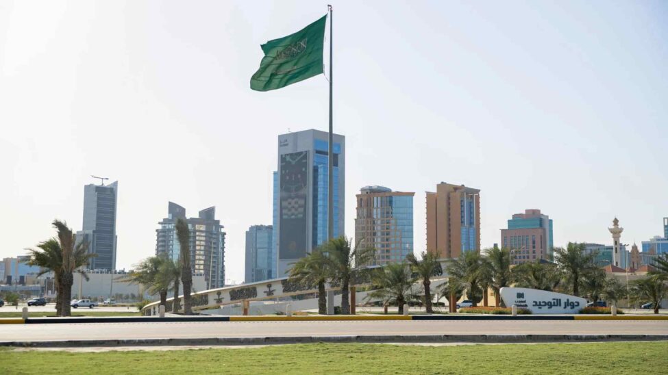 Modern skyline of Saudi Arabia with a Saudi flag representing top construction companies