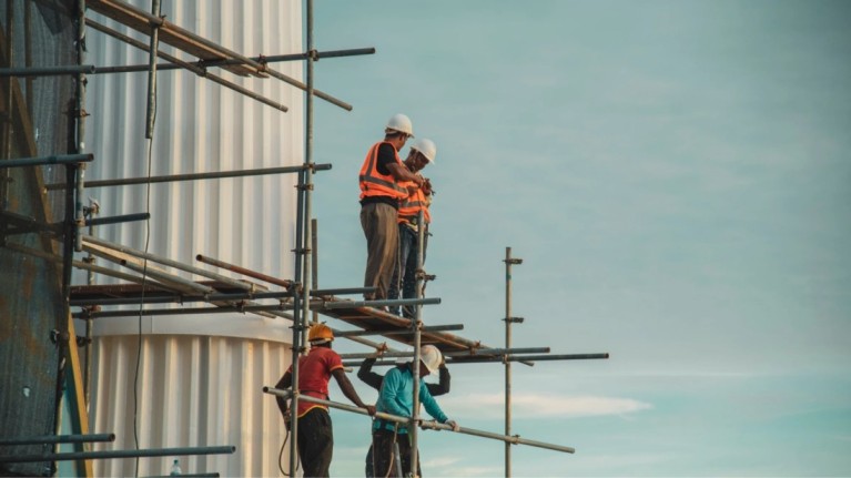 Workers assembling frames during the framing stage of house construction