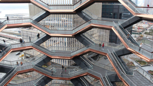 A visually striking open newel staircase with interconnected landings in a modern urban structure.