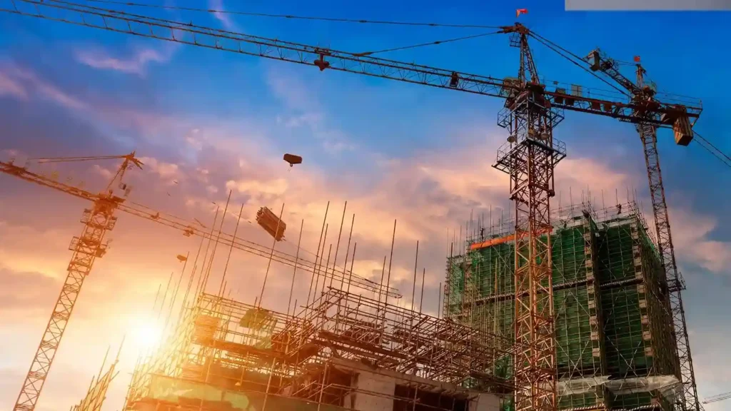 Construction site with scaffolding and cranes at sunset, symbolizing the significance of various types of scaffolding in construction.